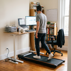 Man walking on the Belva walking pad at a standing desk while working